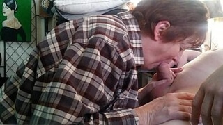 Зрелая дама в клетчатой рубахе берет в рот пенис мужика перед камерой